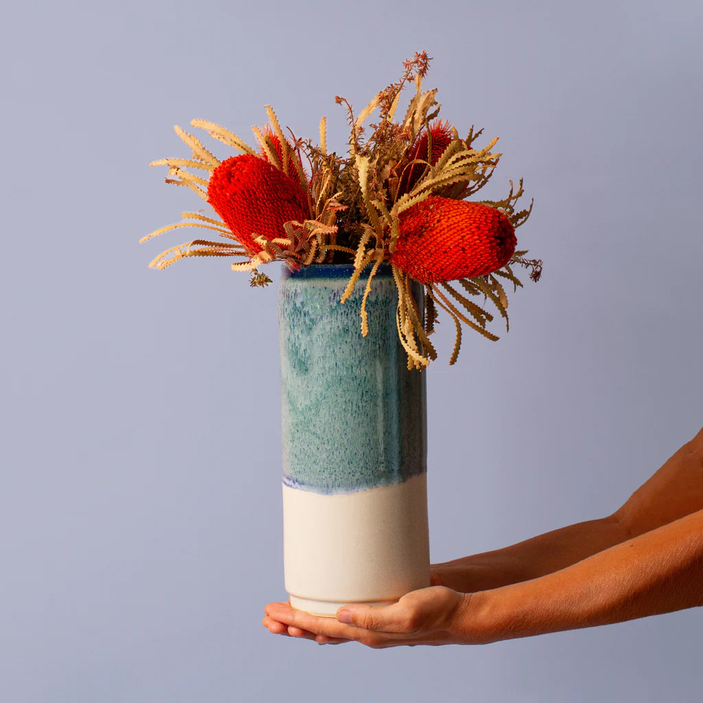 Cylinder vase in blue with red banksia