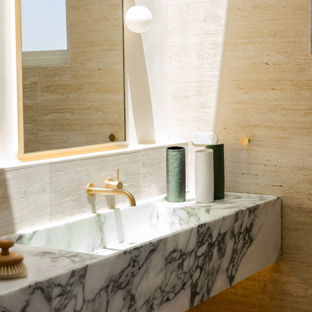 Three Bernie ceramic vases sitting on a bathroom sink
