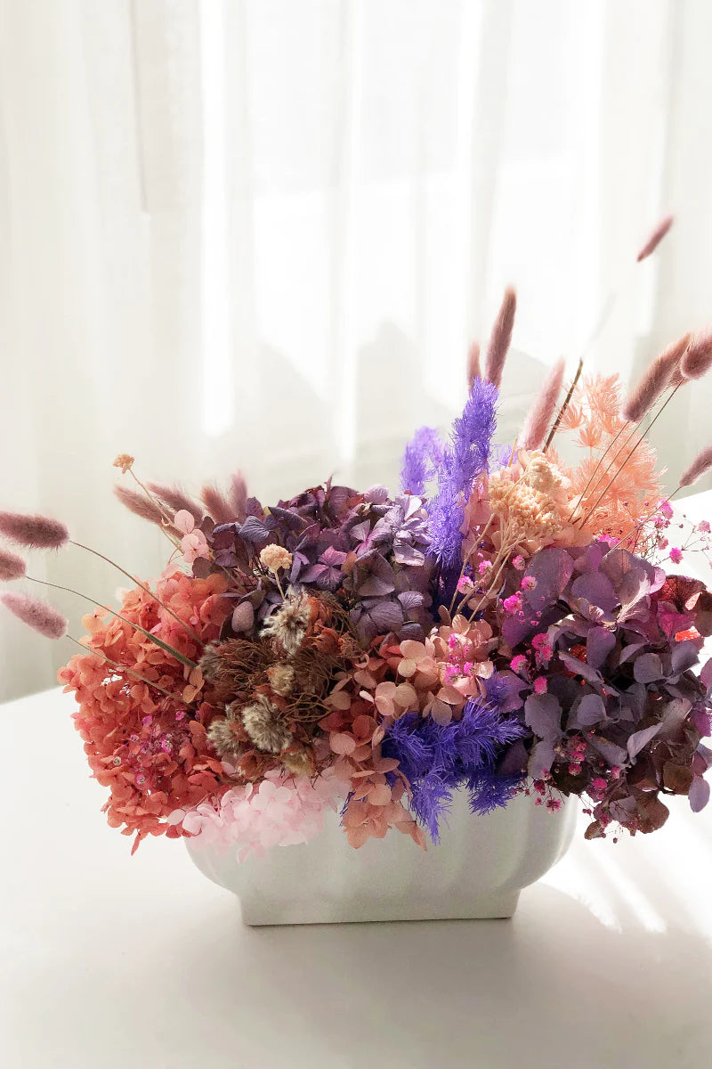 White vase with dried flower arrangement