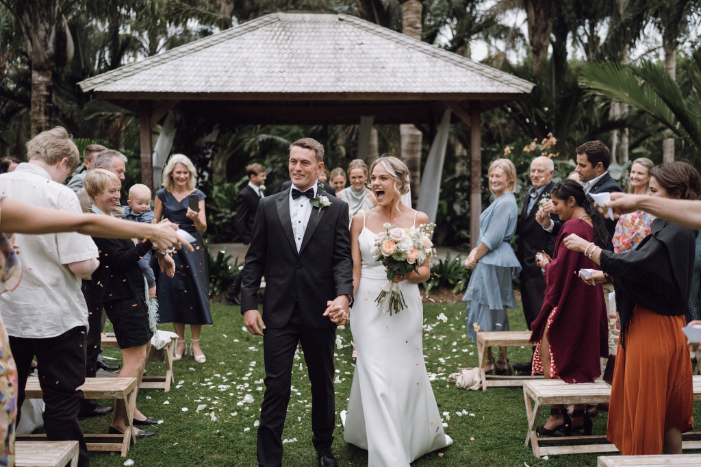 Bride smiling and carrying a fresh flower bridal bouquet