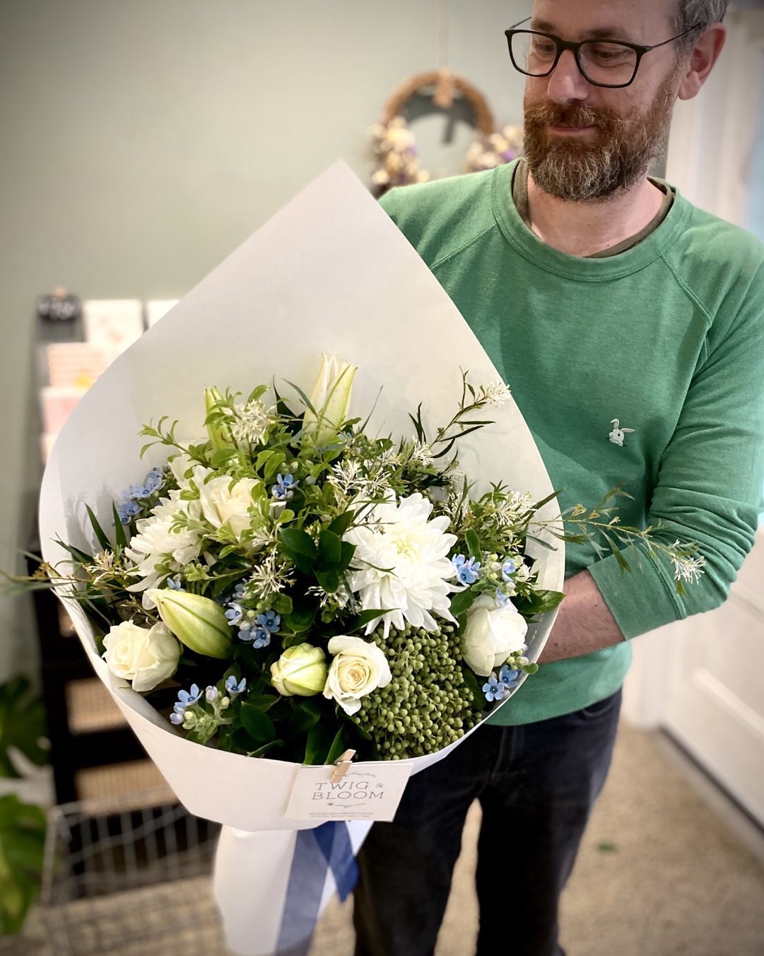 Robin holding a fresh flower bouquet