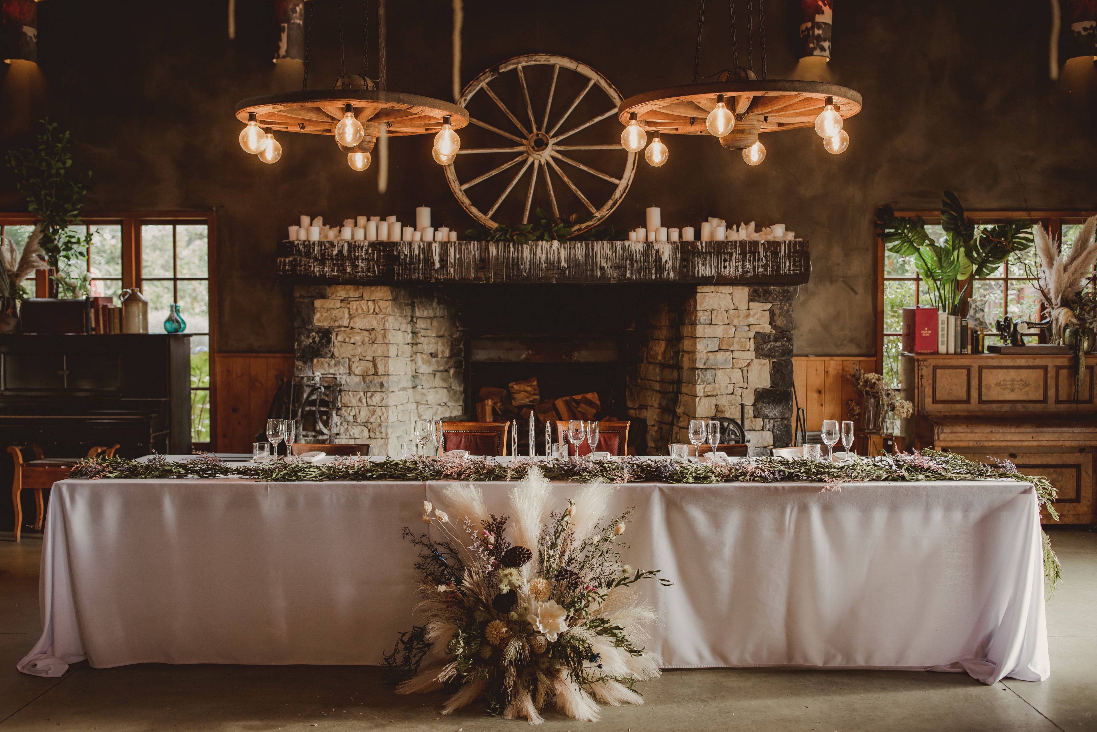 Dried flower arrangements for a rustic wedding reception at The Stables in Matakana