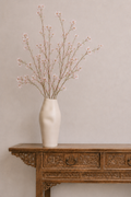 Ceramic vase with tall wild orchids