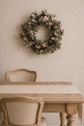 Fauxe eucalyptus wreath hanging on a dining room wall.